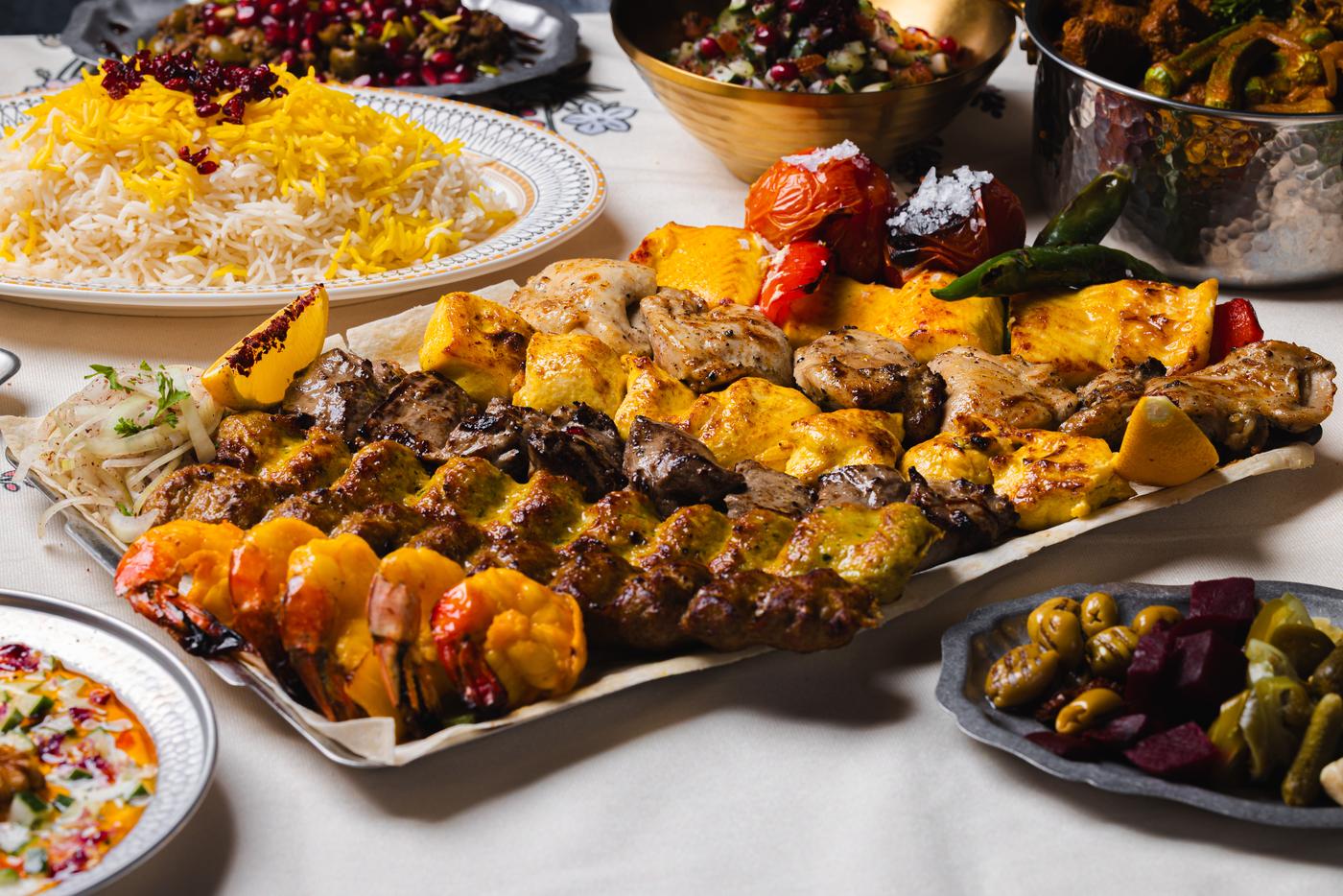The Shirazi grilled platter: koobideh, jujeh, prawns and grilled tomato over the full table