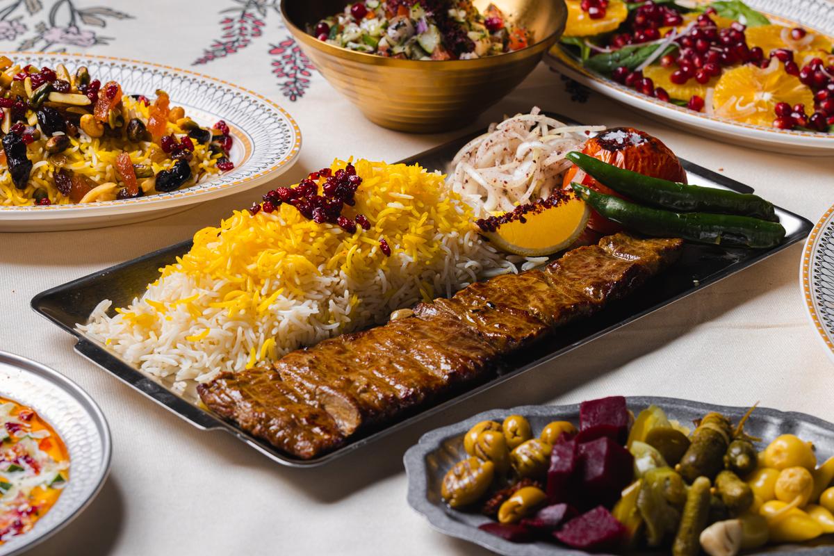 Lamb koobideh with saffron rice, barberries and grilled tomato