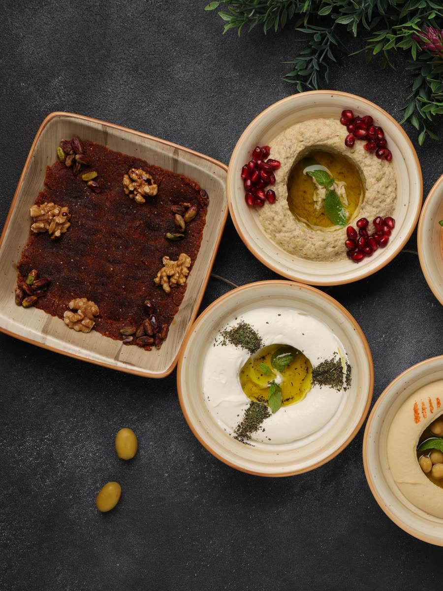 Persian mezze at Shirazi: kashk-e bademjoon, mast o khiar and hummus with pomegranate